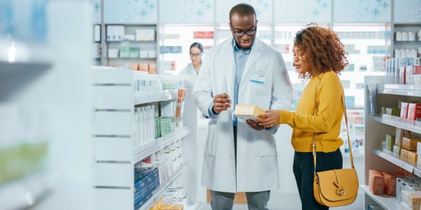 Pharmacist assisting customer in a pharmacy.