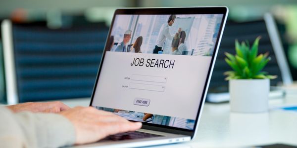 A laptop open at a job search page