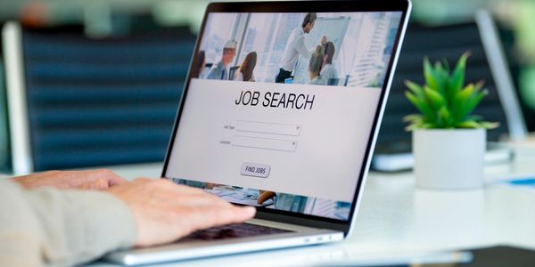 A laptop open at a job search page