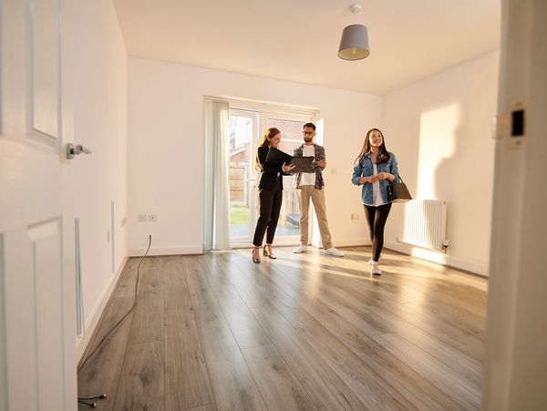 Buyers touring bright empty home