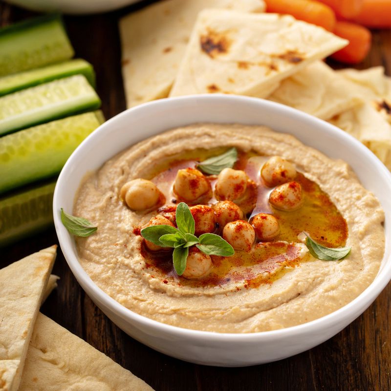 Homemade hummus served with flatbread and vegetables