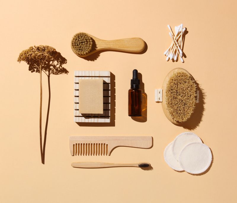 Eco friendly toiletries and beauty products: face and body brushes, cotton pads and swabs, serum, soap, toothbrush and hair comb