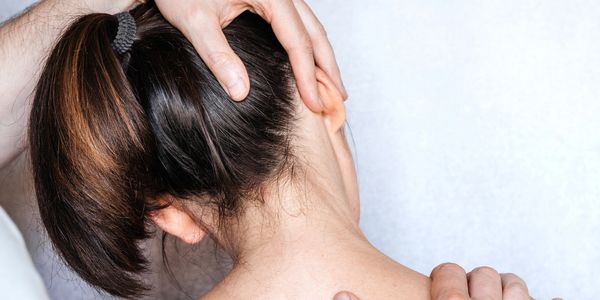 Medical examination of female patient with cervical pain