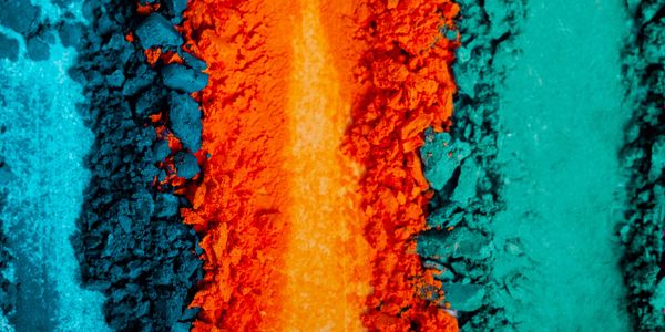 Colorful powdered pigments in blue, orange, and turquoise hues.