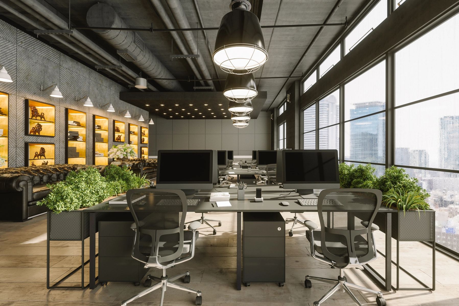 Modern office workspace with computers and greenery by large windows.