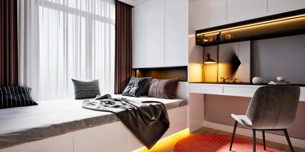 Modern bedroom with cozy bed and study area.