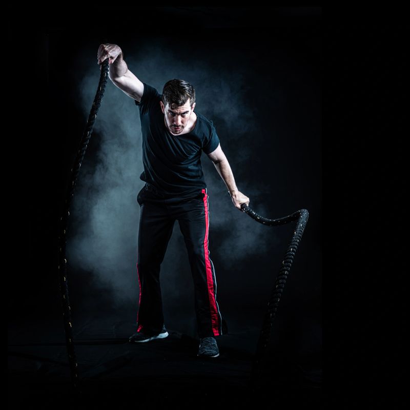 Hispanic Athlete using battle ropes