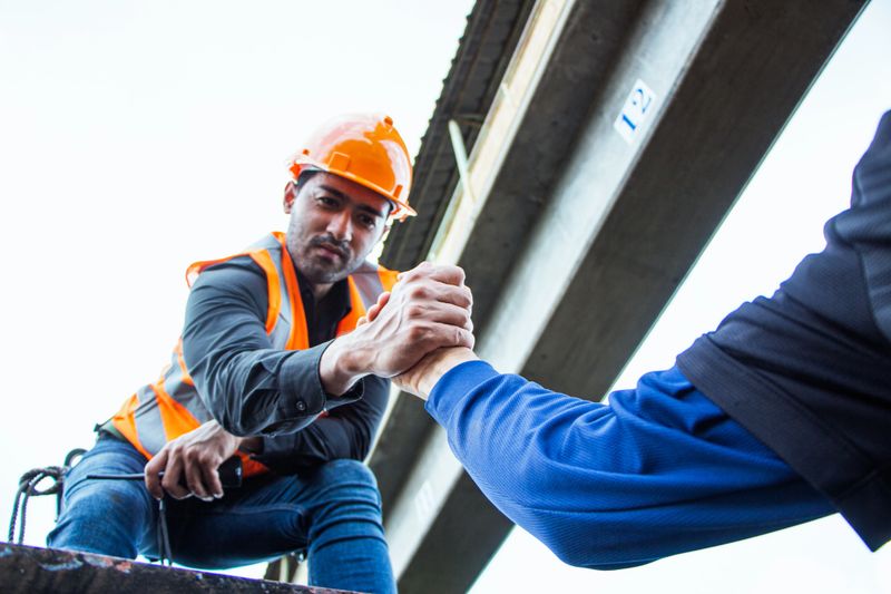Inspector Engineering wearing helmet and vest worker unifrom checking railway construction work on rail track.
