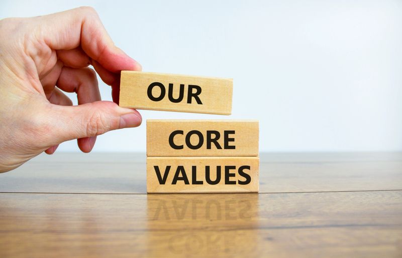 Our core values symbol. Wooden blocks with words 'Our core values'. Beautiful wooden table, white background. Business and our core values concept. Copy space.