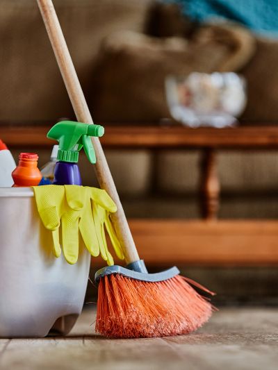 Cleaning supplies with broom and gloves.