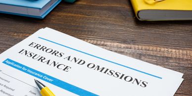 Close-up of an errors and omissions insurance application on a wooden desk.