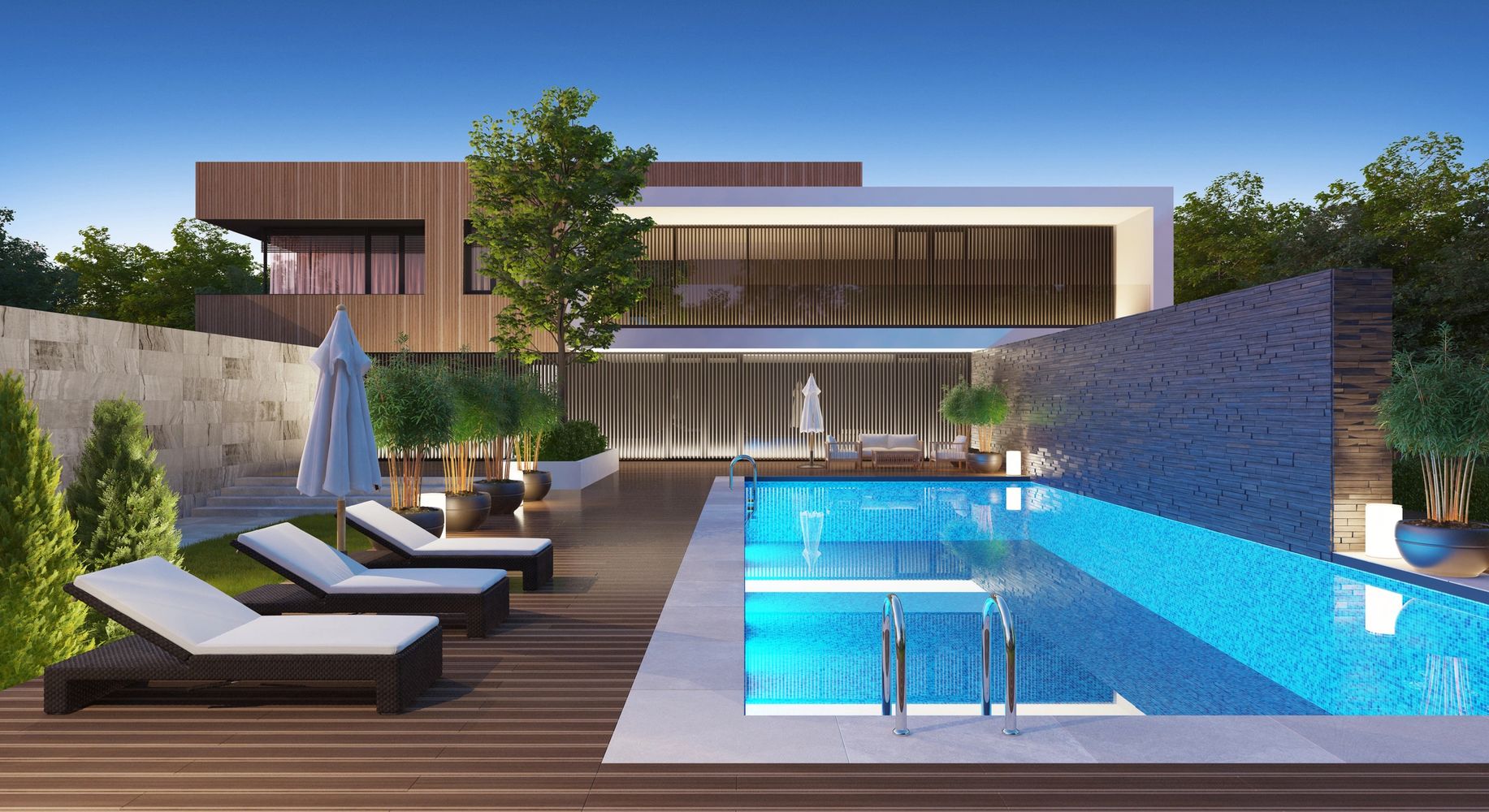 Modern house with a sleek pool and lounge chairs under a clear sky.