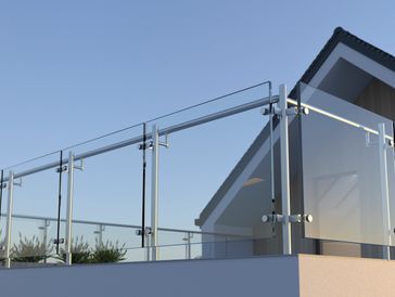 Modern glass railing on a balcony with clear sky background.