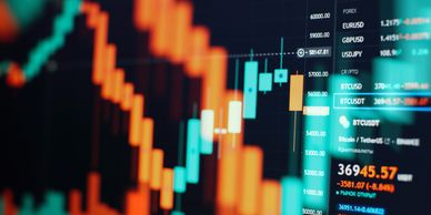 Investment portfolio trading chart with candlesticks and price data on a digital screen.