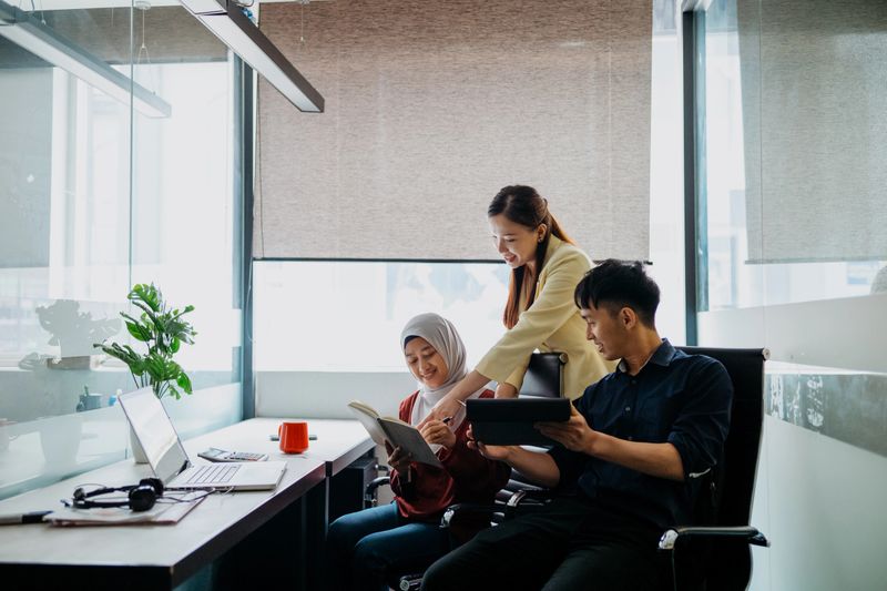 Image of a multi racial Asian business team working in office. Business meeting, brainstorming, discussion, co-working in office.