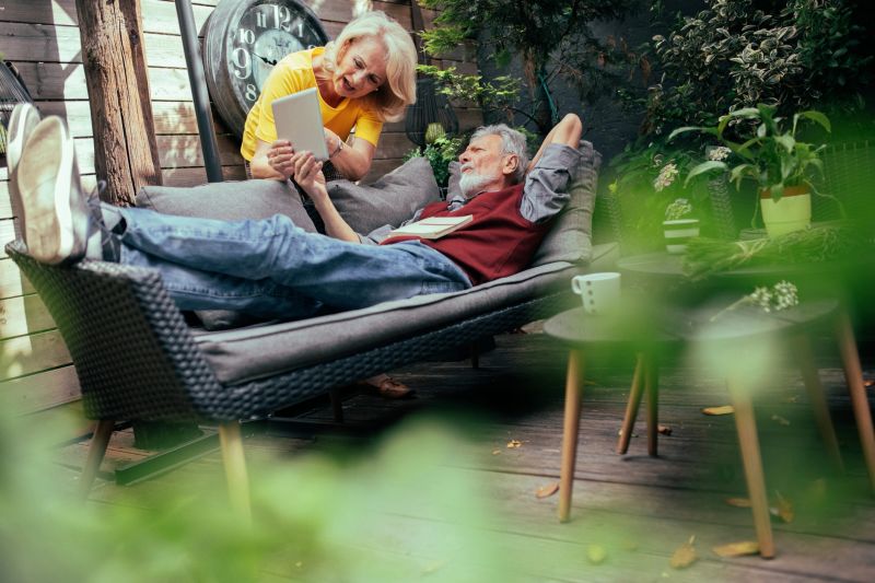 A serene retirement scene with a couple enjoying leisure time, embodying financial peace of mind.