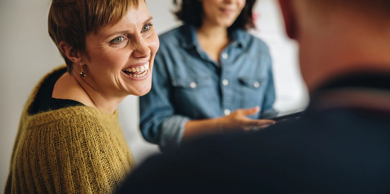 group of people smiling and conversing with ease