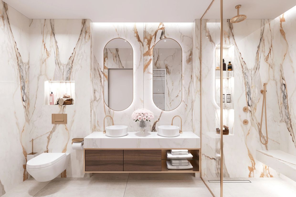 Luxurious modern bathroom with marble walls and gold accents.