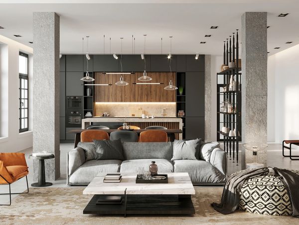 Modern open-plan living room with gray sofa, marble coffee table, and kitchen in the background.