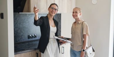 Two women discussing in a modern kitchen.