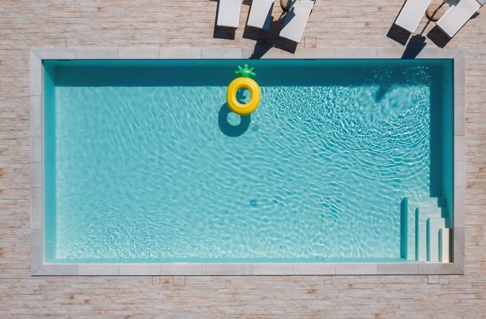 Beautiful outdoor pool with clear water and lush surroundings.
