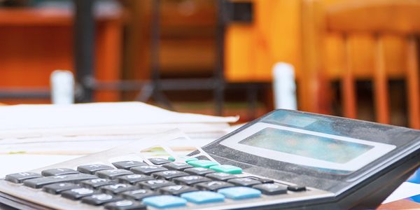 Calculator and financial paperwork representing 33+ years of small business bookkeeping experience.