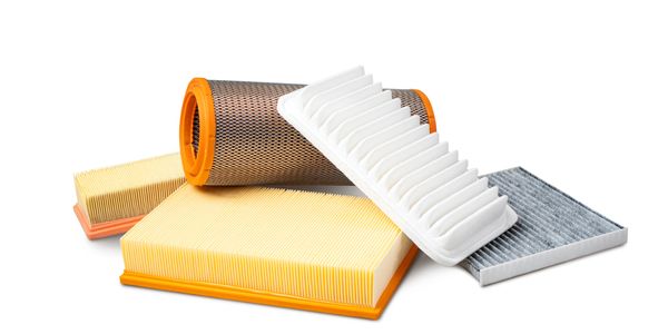 Various automotive air filters of different shapes and sizes on a white background.
