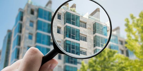Magnified view of a modern building through a magnifying glass.