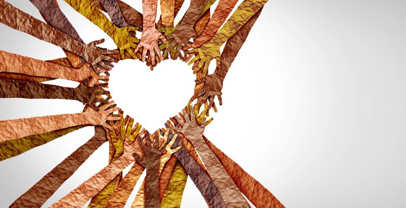 Diverse hands heart and united diversity or unity partnership in a group of multicultural people connected together shaped as a support symbol expressing the feeling of teamwork and togetherness.
