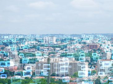 Cityscape overlaid with digital social media message icons.