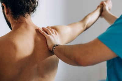 Physical therapy session with arm stretching.