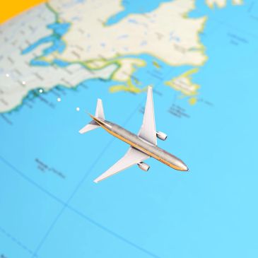 Toy airplane over a world map.