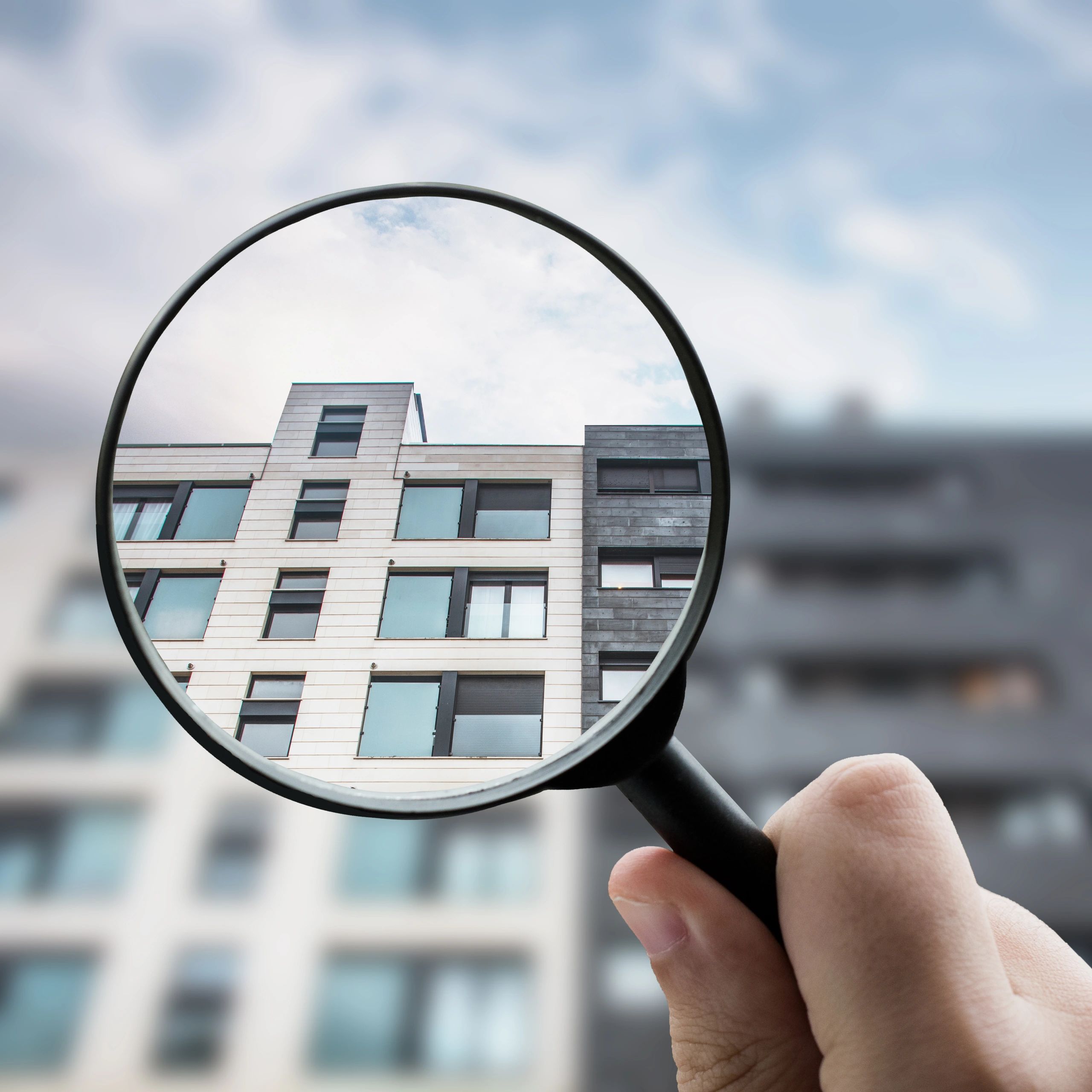 Magnifying glass focusing on a modern building.