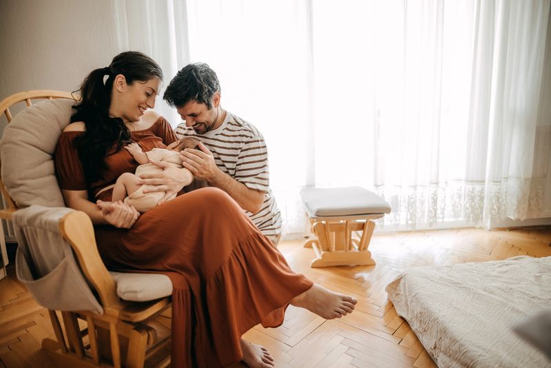 Happy family having newborn, enjoying new life together
