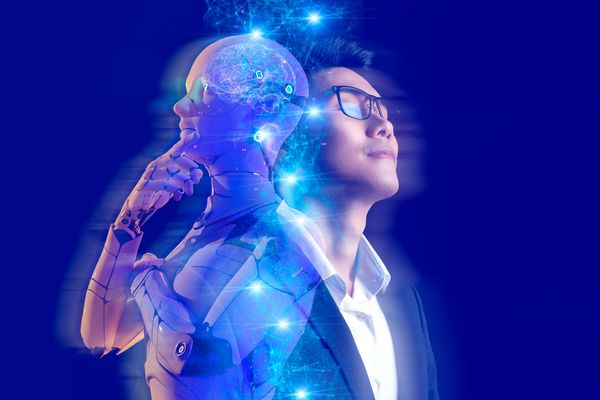 A man and a robot with a glowing brain symbolize AI and human collaboration.
