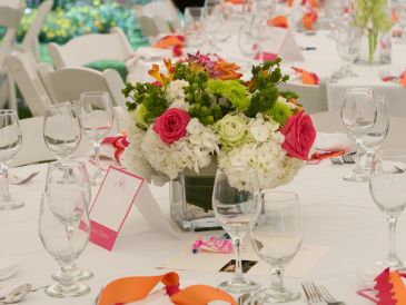 Elegant table setting with floral centerpiece and glassware for an event.
