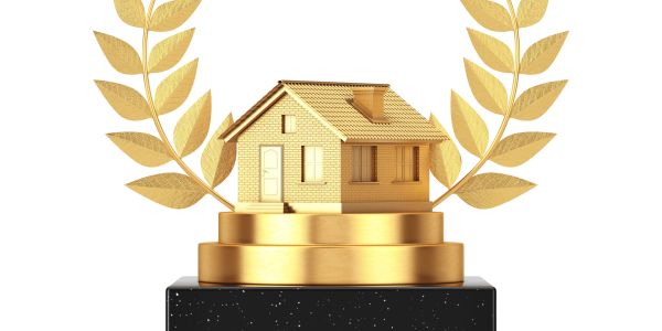Golden house trophy with laurel leaves on a black base.