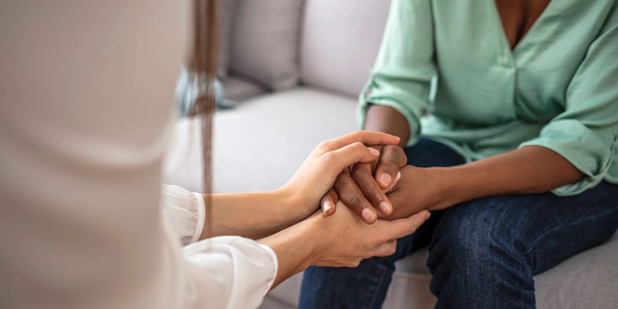 Therapist holding hands with a client