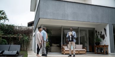 Real estate agent showing a modern house to a couple.