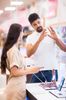 Couple shopping for a new smartphone in a store.