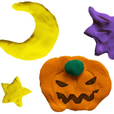 Play dough shaped into a pumpkin, a star and a crescent moon.