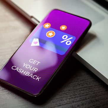 Smartphone displaying a cashback offer with percentage and stars icons.