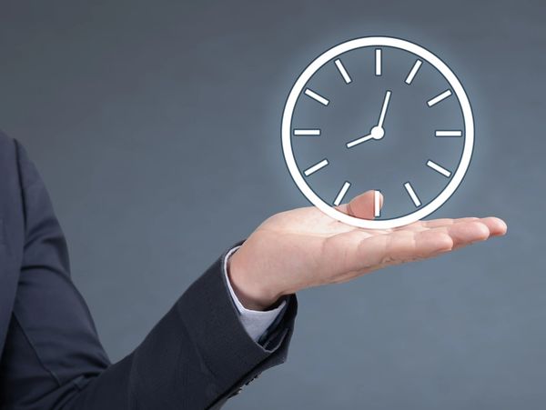 Businessman holding a digital clock illustration in hand.