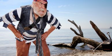 An angry pirate with an eye patch stands on a beach, snarling fiercely.