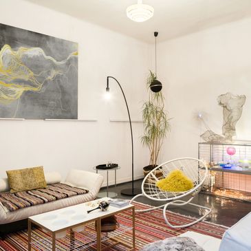 Modern living room with stylish furniture and artistic decor.