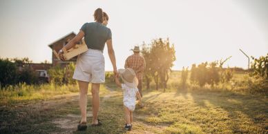 Family walking outdoors on a sunny day.