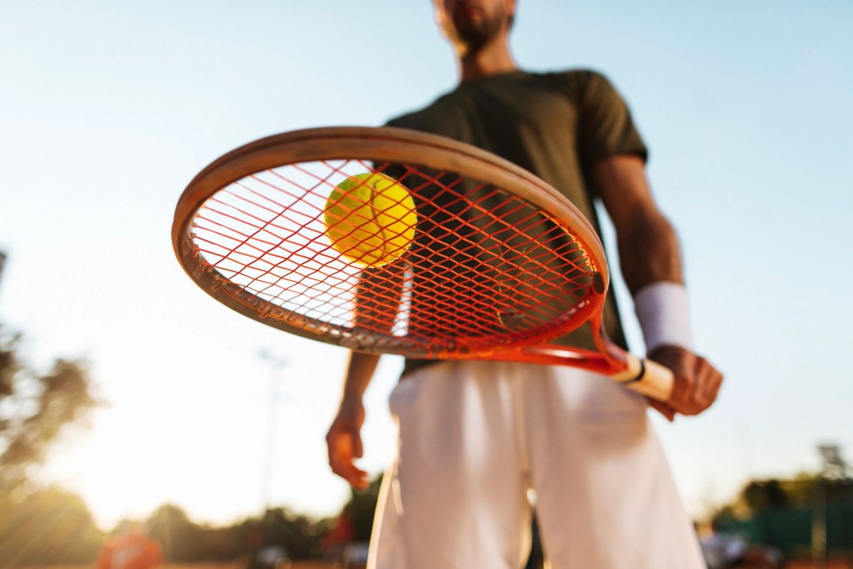 Tennis player with racket and ball.