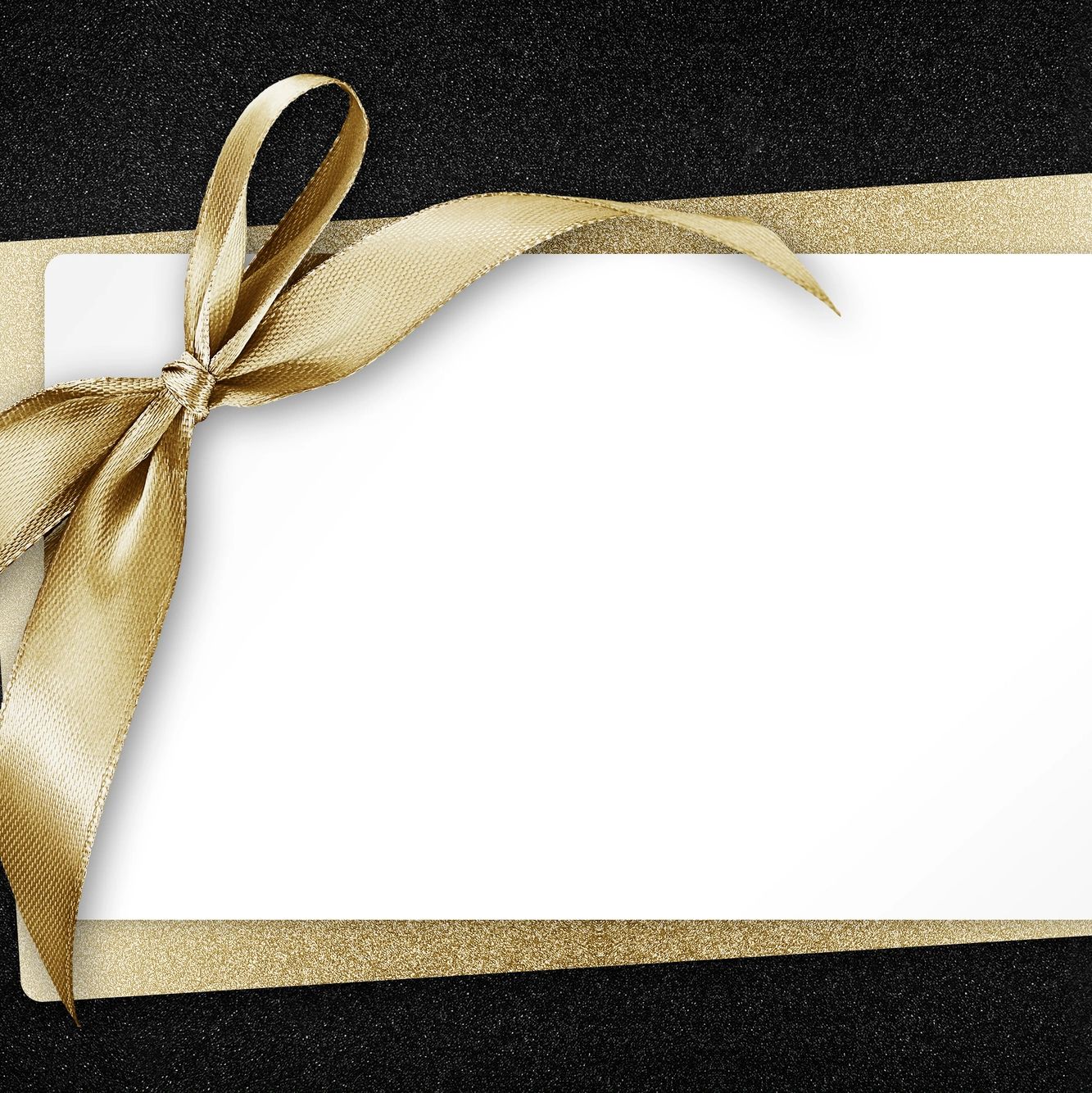Gold ribbon on a white card, with a gold envelope. Glitter black background 