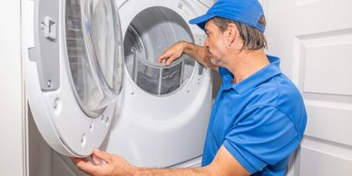 Technician servicing a home dryer. Trusted appliance repair and maintenance in Winnipeg homes.