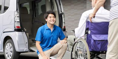 A transportation service is preparing to assist an elderly man into a van from his wheelchair.